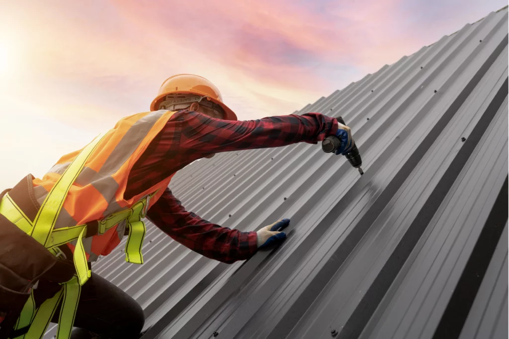 man installing a metal roof